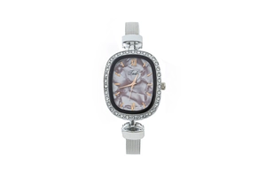 Close-up of Tadi silver oval quartz watch with crystal bezel and marble dial