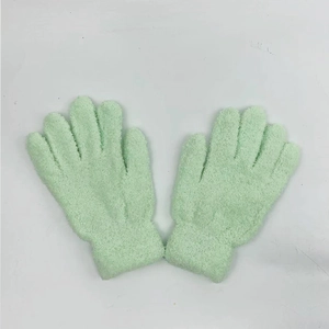 Detail of light green coral fleece gloves with soft texture and elastic cuffs
