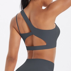 Detail view of charcoal grey sports bra with asymmetric strap and back hollow out design