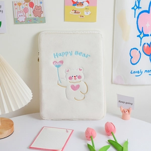 Close-up of cute Happy Bear embroidery on a soft cream plush tablet protective sleeve