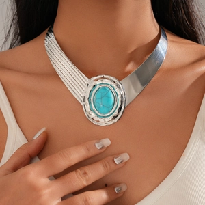 Detail of silver alloy choker with large oval turquoise stone in bohemian style