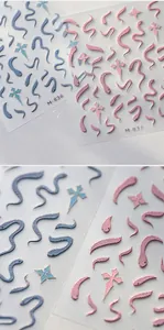 Macro shot of 5D embossed snake nail stickers with golden textures and detailed relief