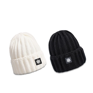 Winter rib-knit beanies in ivory and black with snowflake patch and thick warm texture