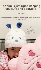 Close-up of kids white microfiber hair towel featuring cute cartoon bear embroidery
