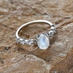 Detailed close-up of a silver vintage ring featuring an oval moonstone and zircons