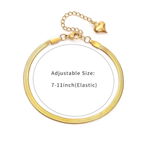 Detail view of gold snake chain with heart charm and adjustable lobster clasp closure