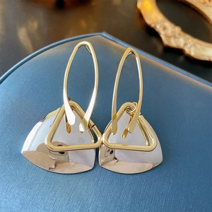Modern geometric hollow triangle earrings in gold metal on premium jewelry box