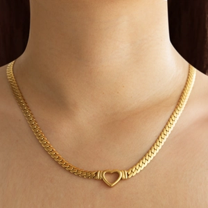 Chunky 18K gold plated heart pendant curb chain necklace shown on a model neck