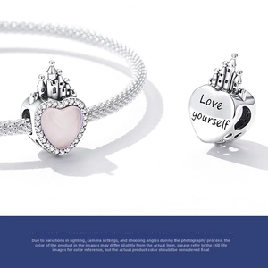 Macro detail of S925 silver heart castle charm with pink zircon and Love yourself engraving