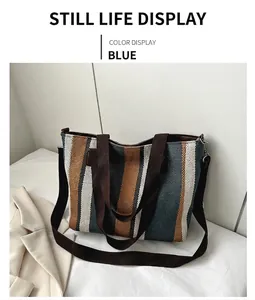 Detail view of large canvas tote bag featuring blue brown and beige woven stripes