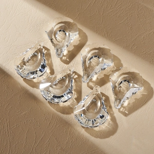 Detail of six teardrop crystal suncatchers with faceted cut surfaces in clear finish