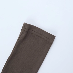 Macro view of brown ribbed knit sleeve cuff showing precise double-needle stitching detail