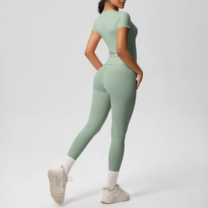 Back view of mint green tight yoga set with short sleeve top and high waist leggings