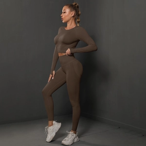 Detail of dark brown seamless knitted crop top and high waist leggings fitness set