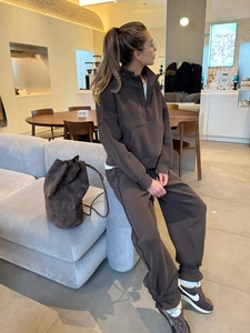 Deep brown two-piece fleece tracksuit featuring half-zip hoodie and jogger pants