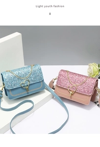 Detail view of pink and blue sequin handbags with heart-shaped clasps and metal chains