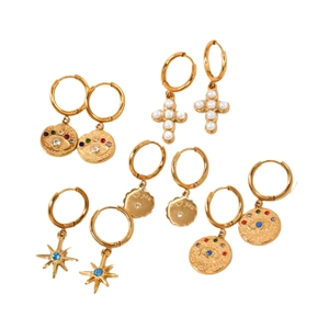 Set of five gold titanium steel hoop earrings with evil eye, cross, and star charms