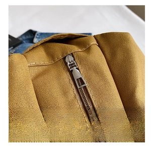 Detailed close-up of high-quality zipper closure and neat stitching on canvas tote bag