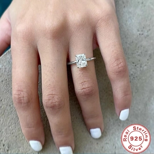 Macro shot of rectangular radiant cut zircon set in silver ring on a woman finger