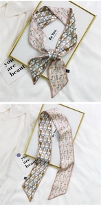 Detail of silk twilly hair scarf with abstract face line art and geometric shapes