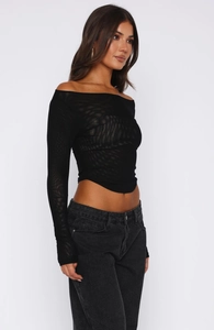 Detail of sheer black mesh long sleeve crop top with off-the-shoulder neckline and slim fit