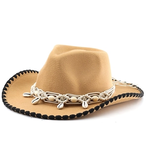 Detail of khaki felt cowboy hat featuring shell accents and woven rope band decoration