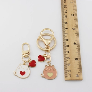 Cat alloy keychains size comparison in white and pink enamel finish with heart charms
