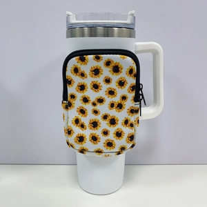 Close-up of white 40oz tumbler with a sunflower neoprene sleeve and zipper detail