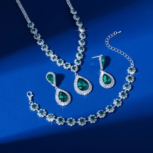 Detailed top view of emerald green rhinestone necklace earrings and bracelet jewelry set