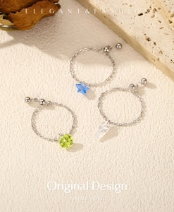 Detailed macro of adjustable s925 silver chain rings with colorful geometric crystal charms