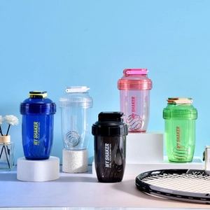 Detail showing five colorful fitness shaker bottles with metal mixing balls for protein shakes