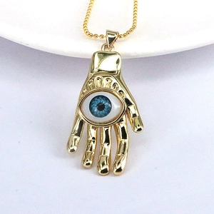 Golden Hamsa necklace with blue Evil Eye pendant on a minimalist thin bead chain