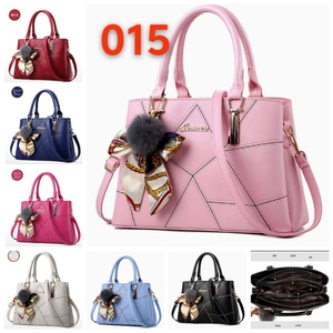 Detail view of stylish handbag showing internal multi-layer structure and accessories