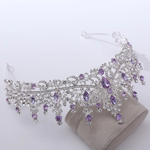 Macro detail of silver bridal crown with purple crystals and luxury rhinestone tassels