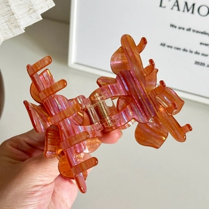 Floral orange-pink iridescent hair claw clip in large size for elegant updo hairstyles