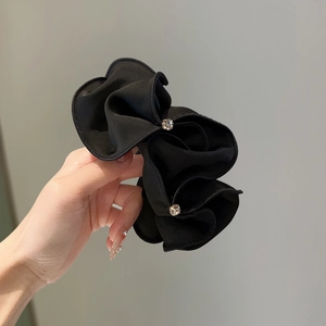 Elegant black pleated scrunchie hair tie with sparkling crystals for ponytails