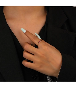 Detail of a 925 silver gold-plated ring with a rectangular pink gemstone on a model hand