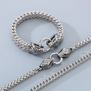 Detail of 6mm dragon bone chain set with dual snake heads in polished stainless steel