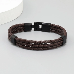 Detail of dark brown braided leather multilayer bracelet with black metal clasp buckle