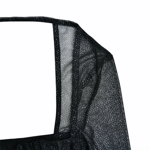 Close-up of black mesh fabric with silver sequins on a square neck long sleeve dress