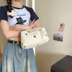 Quilted bow embroidery makeup bag in cream white with convenient side handle