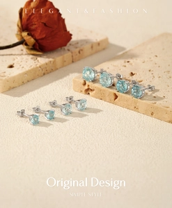 Detailed shot of S925 sterling silver studs with round-cut light blue firework gemstones