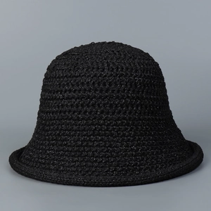 Close-up of black hollow knit bucket hat with shimmering thread and woven texture