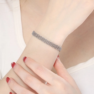 Close-up of four-strand silver braided titanium steel bracelet worn by a model