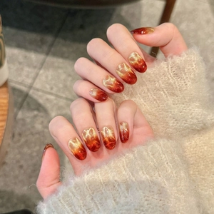 Detail of handmade burgundy cat eye press-on nails with starry gradient shimmer effect