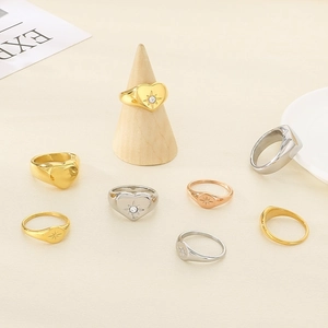 Polished 18K gold plated titanium steel rings with heart and starburst engraving