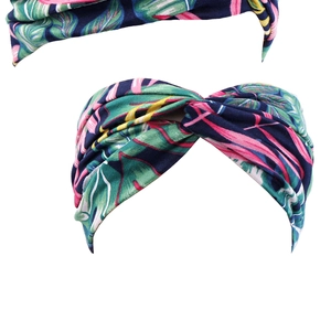 Detail of tropical leaf print on soft blue stretch fabric wide elastic headband