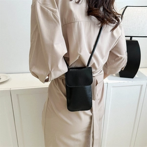 Chic black leather square crossbody bag worn by a model in a minimalist setting