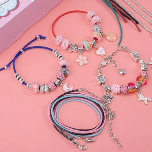 Detail of pink DIY jewelry set featuring colorful beads and unicorn heart pendants