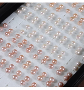 Macro view of assorted natural freshwater pearl studs in white, pink, and lavender hues